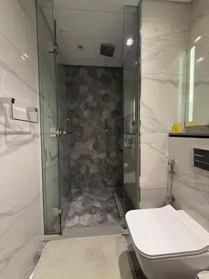 a bathroom with a shower and a toilet at Furnished Studio 2 min Walk to Burji Khalifa in Dubai