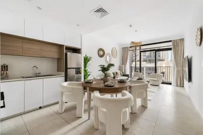 a kitchen and dining room with a table and chairs at Luxurious 1BR Modern Apartment Balcony Pool in Dubai
