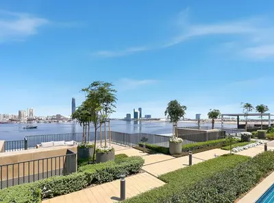 a walkway with a view of the water at Luxurious 1BR Modern Apartment Balcony Pool in Dubai