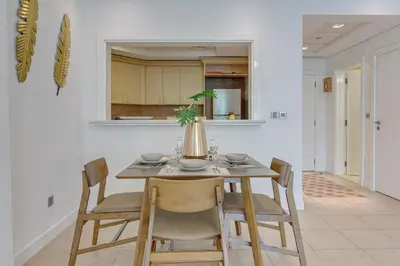 a dining room table and chairs in a kitchen at Al Sarrood, Palm Jumeirah - 1 Bedroom Apartment - Allsopp & Allsopp in Dubai