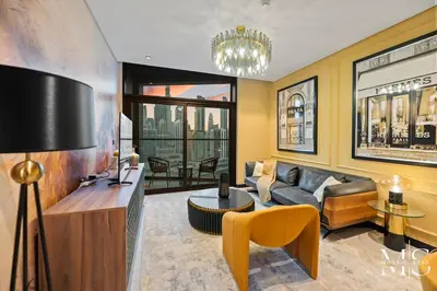 a living room with a couch and a table at Luxury High Floor 1BHK Burj and Canal Views in Dubai