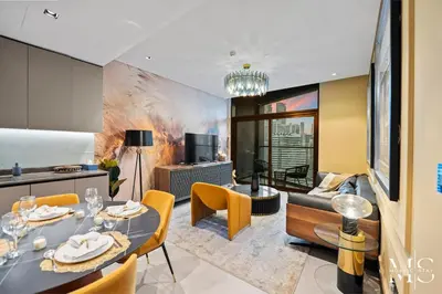 a living room with a table and chairs and a couch at Luxury High Floor 1BHK Burj and Canal Views in Dubai