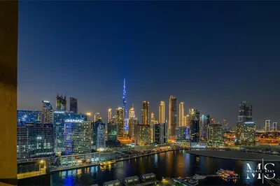 a view of a city skyline at night at Luxury High Floor 1BHK Burj and Canal Views in Dubai