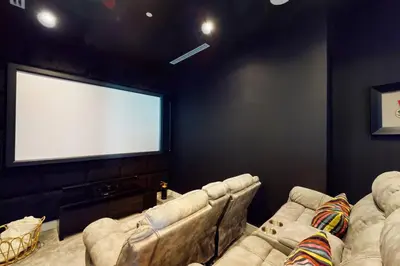 a living room with two couches and a large screen at Vacationer l Magnificent 4 Bedroom l Penthouse l Marina Views in Dubai