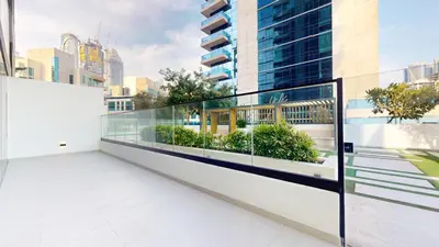 a balcony with glass walls and a view of the city at Vacationer l 1 Bedroom in Business Bay l Direct Pool Access in Dubai