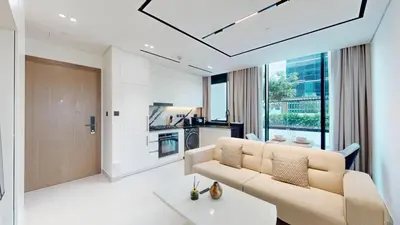 a living room with a couch and a table at Vacationer l 1 Bedroom in Business Bay l Direct Pool Access in Dubai