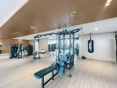 a gym with several tread machines in a room at Vacationer l 1 Bedroom in Business Bay l Direct Pool Access in Dubai