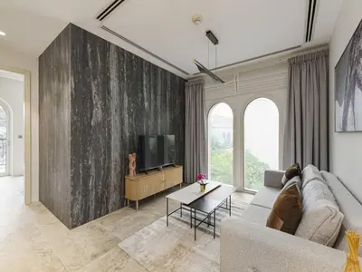 a living room with a couch and a tv at Redwood Townhouse Jumeirah Golf Estates in Dubai