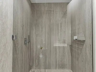a shower with a glass door in a bathroom at Redwood Townhouse Jumeirah Golf Estates in Dubai