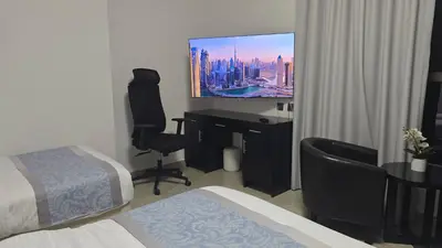 a hotel room with a television and a desk with a bed at Beach, Palm Jumeirah & Marina view in Dubai