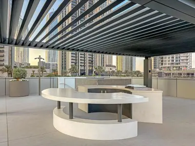 a table in an office with a view of a city at FIRST CLASS 1BR Creek Escape & Modern Elegance in Dubai