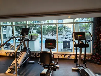 a gym with three exercise bikes in front of a window at 1 Bedroom in Dubai Marina Walk, Partial Water View in Dubai