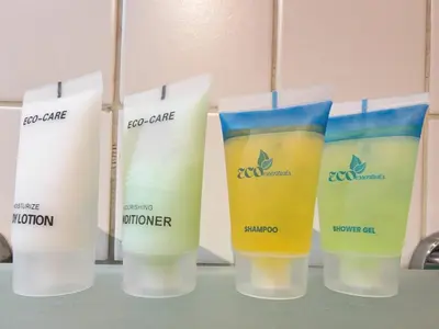 a group of four bottles of sunscreen on a shelf at 1 Bedroom in Dubai Marina Walk, Partial Water View in Dubai