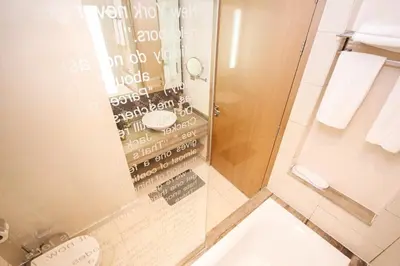 a bathroom with a shower and a toilet in it at Newly Furnished Luxury 1BHK at Paramount Tower D in Dubai