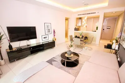 a living room with a large flat screen tv at Newly Furnished Luxury 1BHK at Paramount Tower D in Dubai