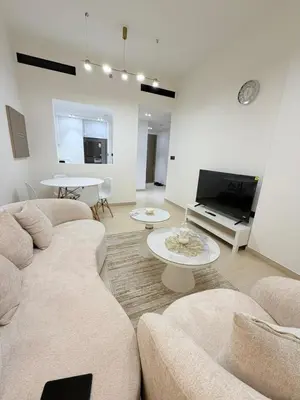 a living room with two couches and a tv at Luxury Binghatti Crest 1BR Apartment with Pool & Balconies in Dubai