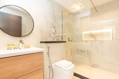 a bathroom with a toilet and a sink and a mirror at PVH - Refined 1BR in Marina - Cayan Tower in Dubai