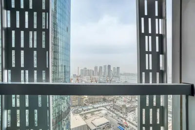 a view of a city from a window in a skyscraper at PVH - Refined 1BR in Marina - Cayan Tower in Dubai