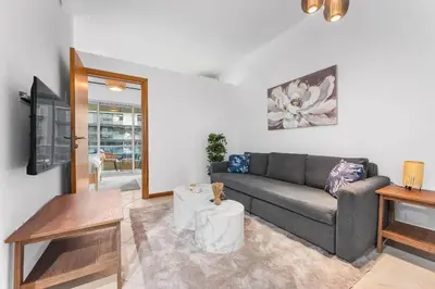 a living room with a couch and a table at StayShort - 1 Bed Apartment Sleeps 4 in Dubai Marina in Dubai