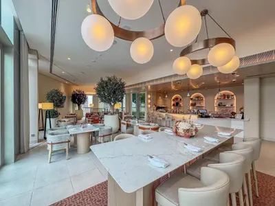 a restaurant with a large table and chairs at Frank Porter - Vida Residences Dubai Mall in Dubai