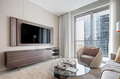 a living room with a television and a couch at Frank Porter - Vida Residences Dubai Mall in Dubai