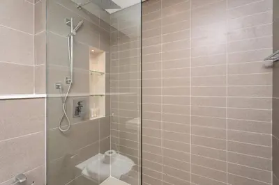 a bathroom with a shower with a glass door at Modern Marina Studio w City Views & King Bed in Dubai