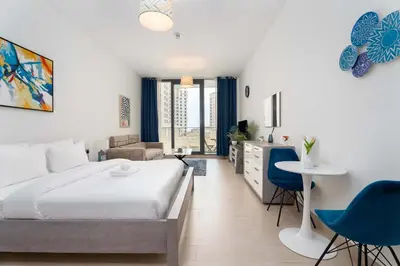 a bedroom with a bed and a living room at Modern Marina Studio w City Views & King Bed in Dubai