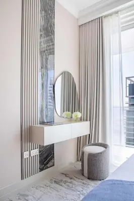 a bedroom with a dressing table and a mirror at Frank Porter - Palace Beach Residence in Dubai