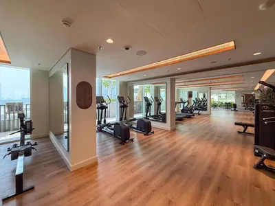 a gym with treadmills and ellipticals in a building at Frank Porter - Palace Beach Residence in Dubai