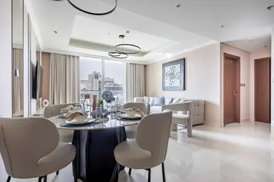 a dining room and living room with a table and chairs at Frank Porter - Palace Beach Residence in Dubai