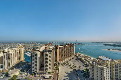 an aerial view of a city and a river at DVH Luxe Retreats at The Palm Tower, Palm Jumeirah, Studio Apartment in Dubai