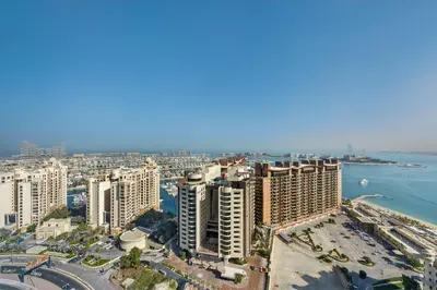 an aerial view of a city and the water at DVH Luxe Retreats at The Palm Tower, Palm Jumeirah, Studio Apartment in Dubai