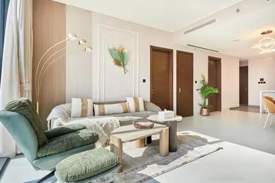a living room with a couch and a chair at STAY BY LATINEM Luxury 3BR Holiday Home CA 0702 Near Burj Khalifa in Dubai
