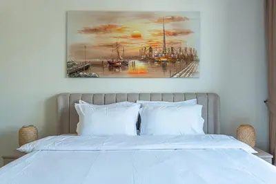 a painting on the wall above a bed at Burj khalifa view I Sofa bed I walking distance to Dubai Mall in Dubai