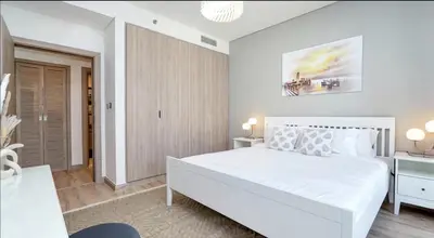 a bedroom with a large white bed in a room at Burj Khalifa and Canal view 2 BDR Apartment in Dubai