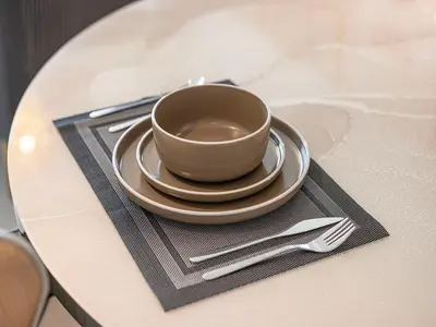 a coffee cup on a plate on a table at Livin' Holidays - 1 BR - Stunning Private beach in Dubai
