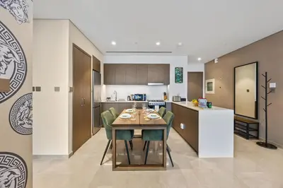 a kitchen and dining room with a table and chairs at Versace 1BR Downtown Burj View From Infinity Pool in Dubai
