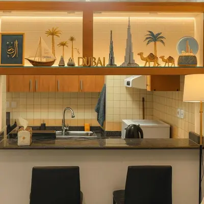 a kitchen with a counter with two chairs and a sink at Luxury studio in Dubai Marina in Dubai