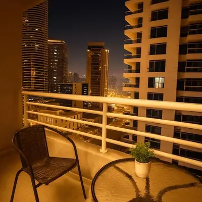 a chair and a table on a balcony with a city skyline at Luxury studio in Dubai Marina in Dubai