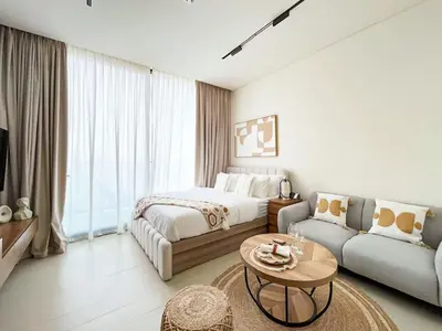 a hotel room with a bed and a couch at Luxe Studio Perch in Binghatti Azure with Pool & Gym in Dubai