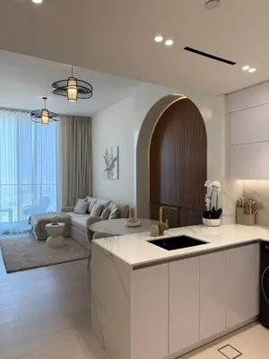 a large kitchen and living room with a couch at High floor luxury apartment JVC in Dubai