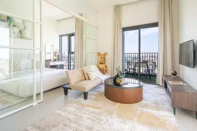 a large living room with a bed and a tv at Cozy 2BR Apartment in Dubai Hills with Cinema and Lounge Access in Dubai