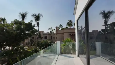 a view from the balcony of a building with palm trees at Signature Palm Villa Exclusive 6 BDR Retreat in Dubai