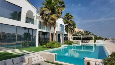an exterior view of a house with a swimming pool at Signature Palm Villa Exclusive 6 BDR Retreat in Dubai