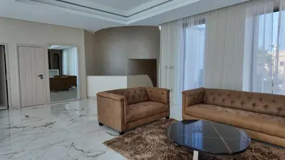 a living room with a couch and a table at Signature Palm Villa Exclusive 6 BDR Retreat in Dubai