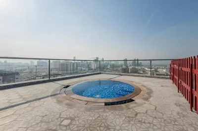 a swimming pool on the roof of a building at Community View 1BR, Perfect Location Near Miracle Garden, Butterfly Garden and Community Spaces, Orion Building, Arjan by Deluxe Holiday Homes in Dubai