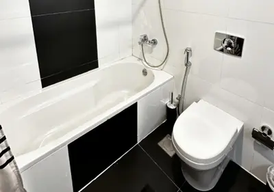 a bathroom with a toilet and a bath tub and a toilet at Modern Studio Apartment with Balcony in JVC in Dubai