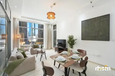 a living room with a couch and a table at Brand New 2-BR Apartment in Dubai Marina - JBR in Dubai