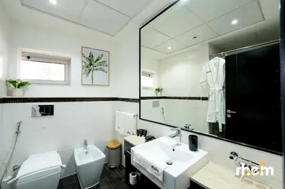 a bathroom with a sink and a toilet and a mirror at Brand New 2-BR Apartment in Dubai Marina - JBR in Dubai