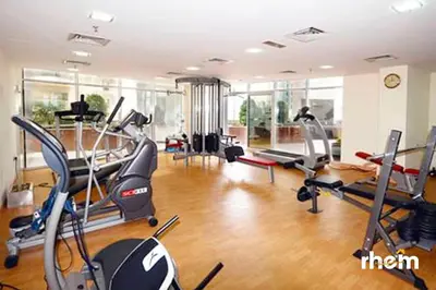 a gym with several treadmills and elliptical machines at Brand New 2-BR Apartment in Dubai Marina - JBR in Dubai